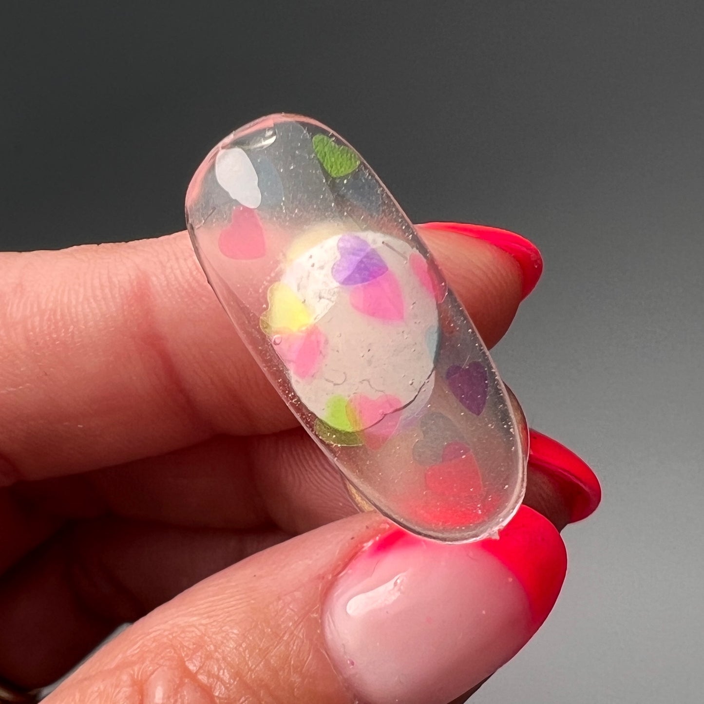 Hand holding decorated nai tip. 