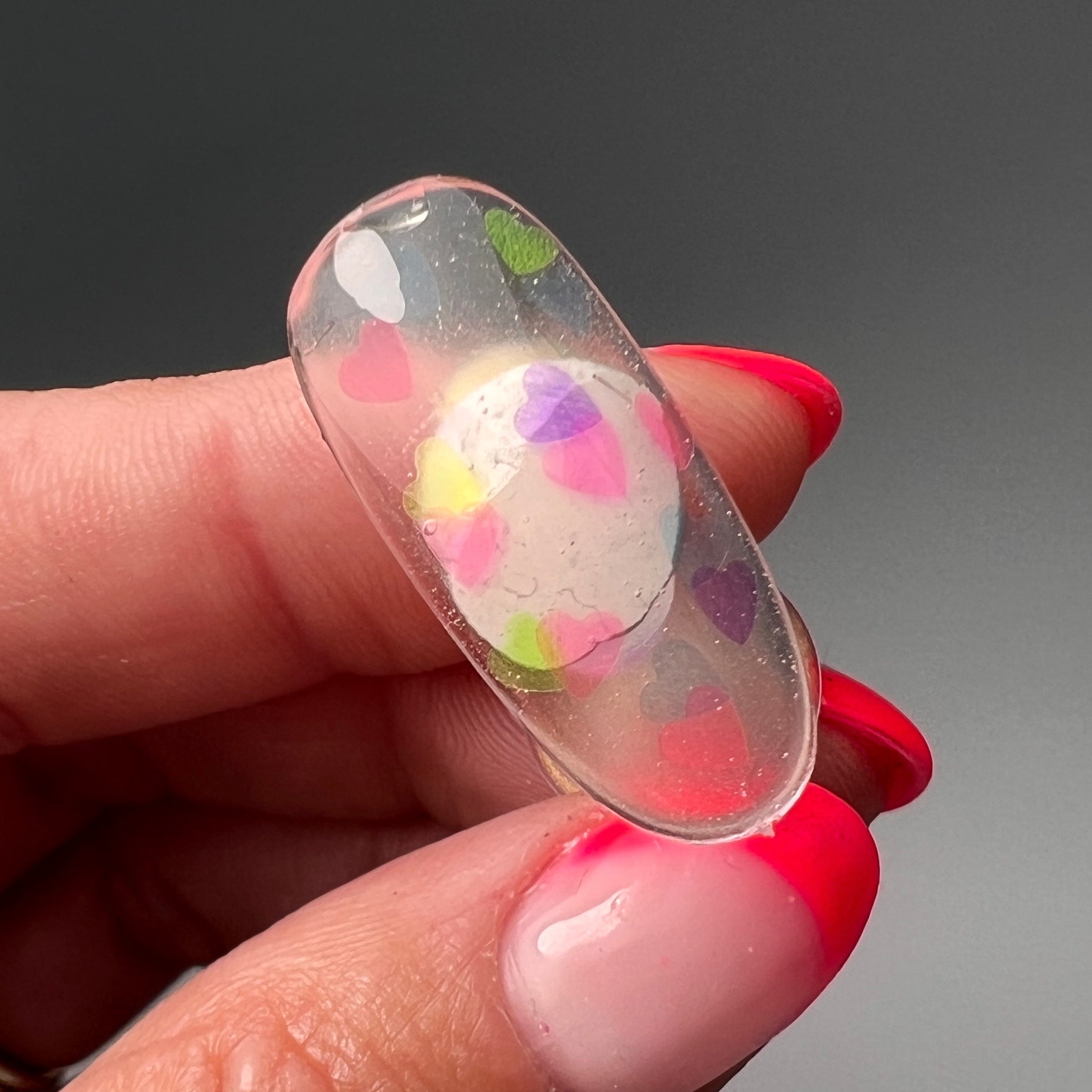 Hand holding decorated nai tip. 
