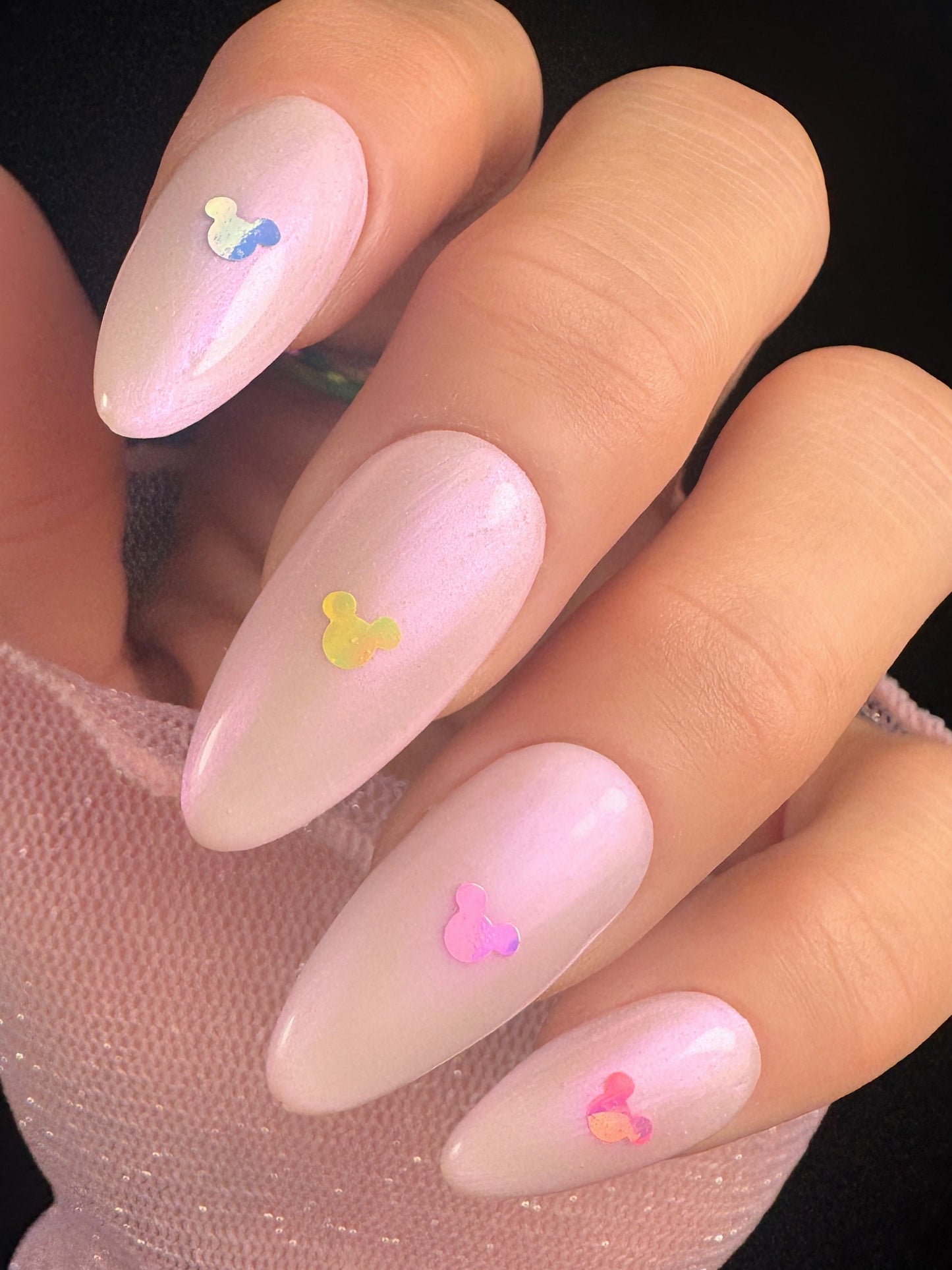 Nails with mouse-shaped decorations on a plain background