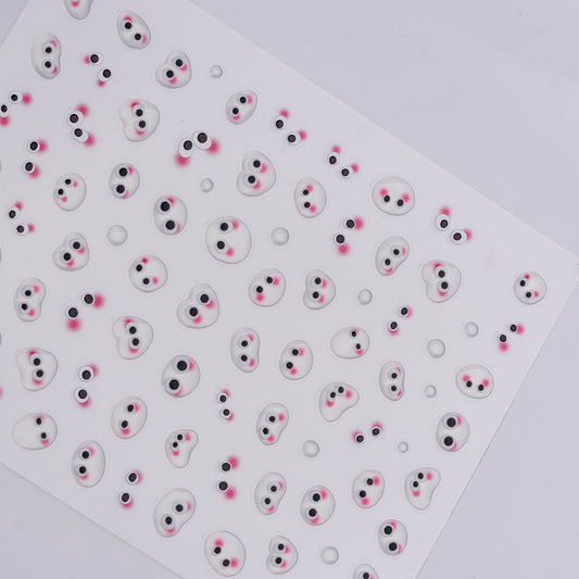 Sheet of small round stickers with cartoonish faces on a white background