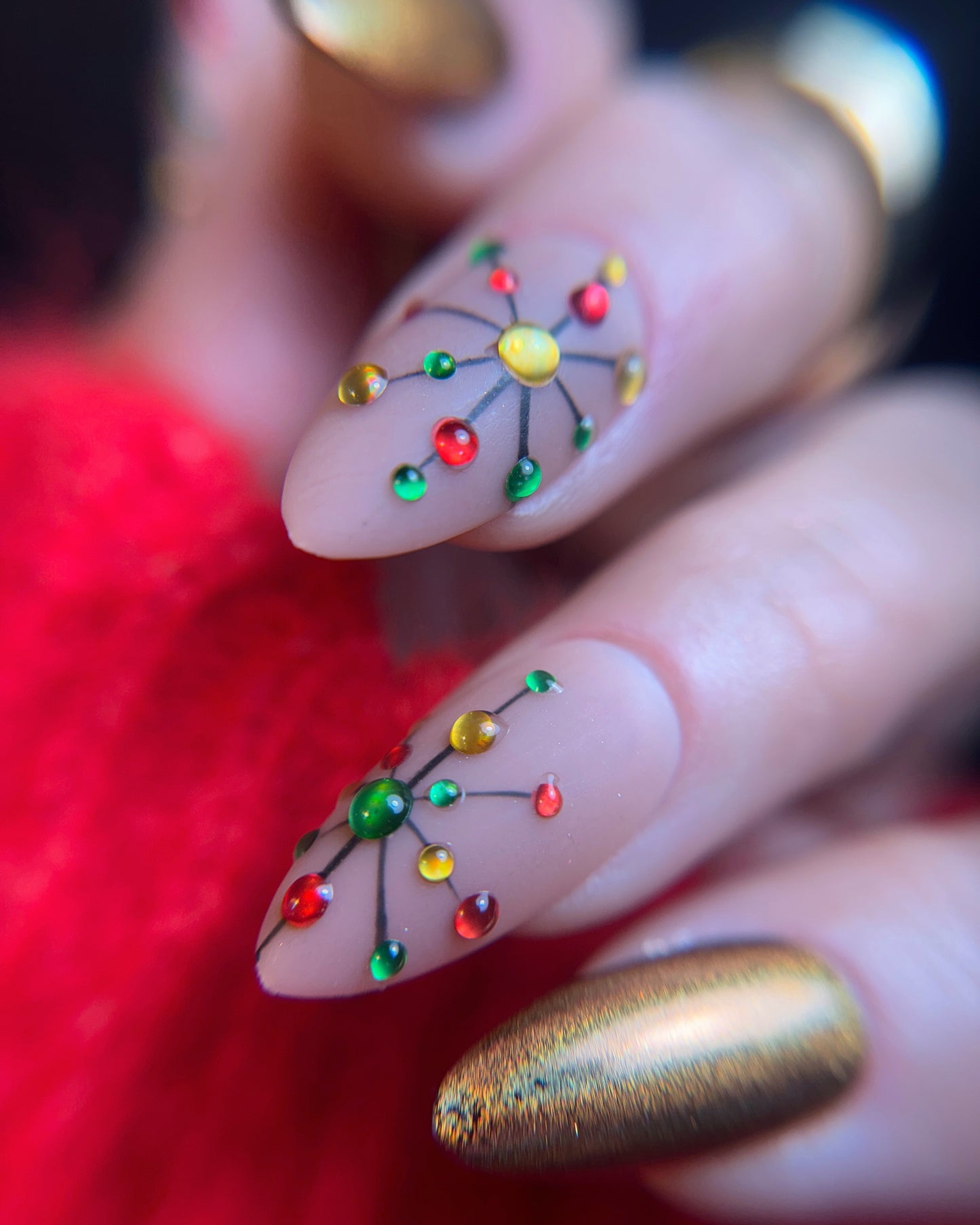 Nail art with colorful design on a red background