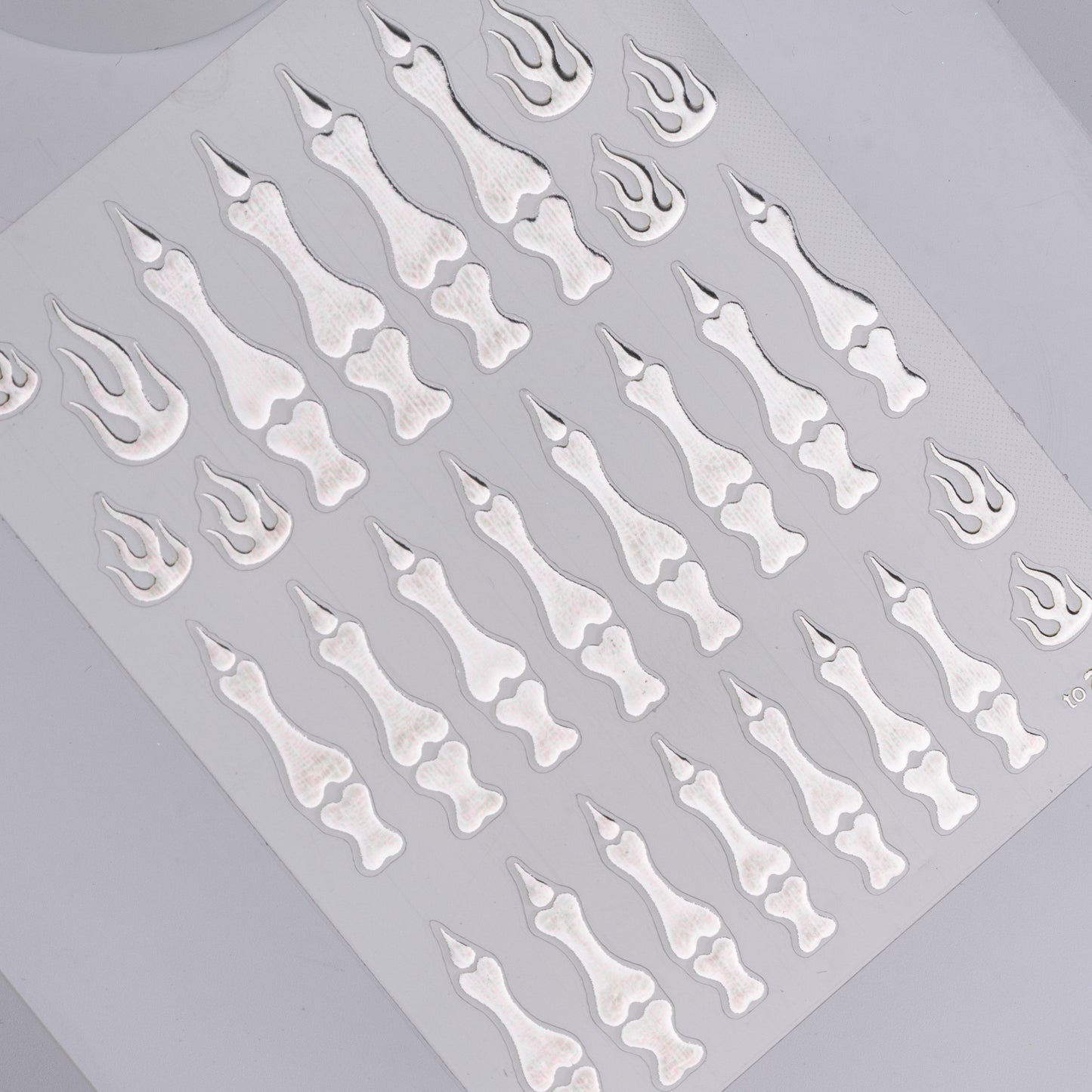 Sheet of bone and flame designs on a gray background