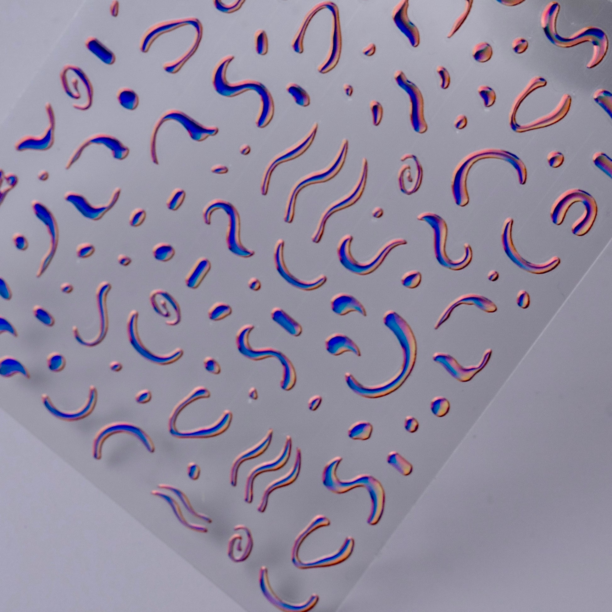 Detail view of nail decal sheet on light background.