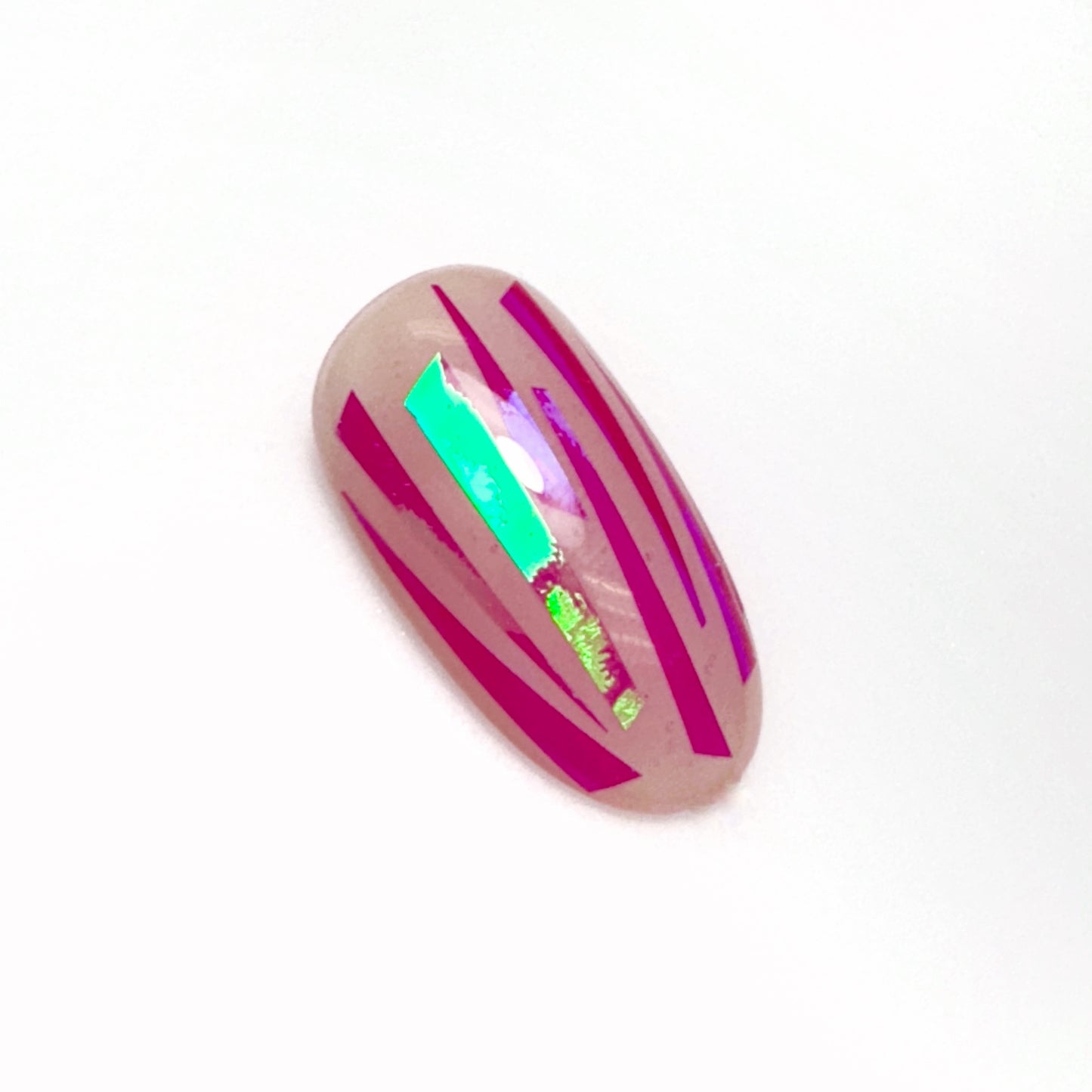 Decorated nail tip on a white surface.