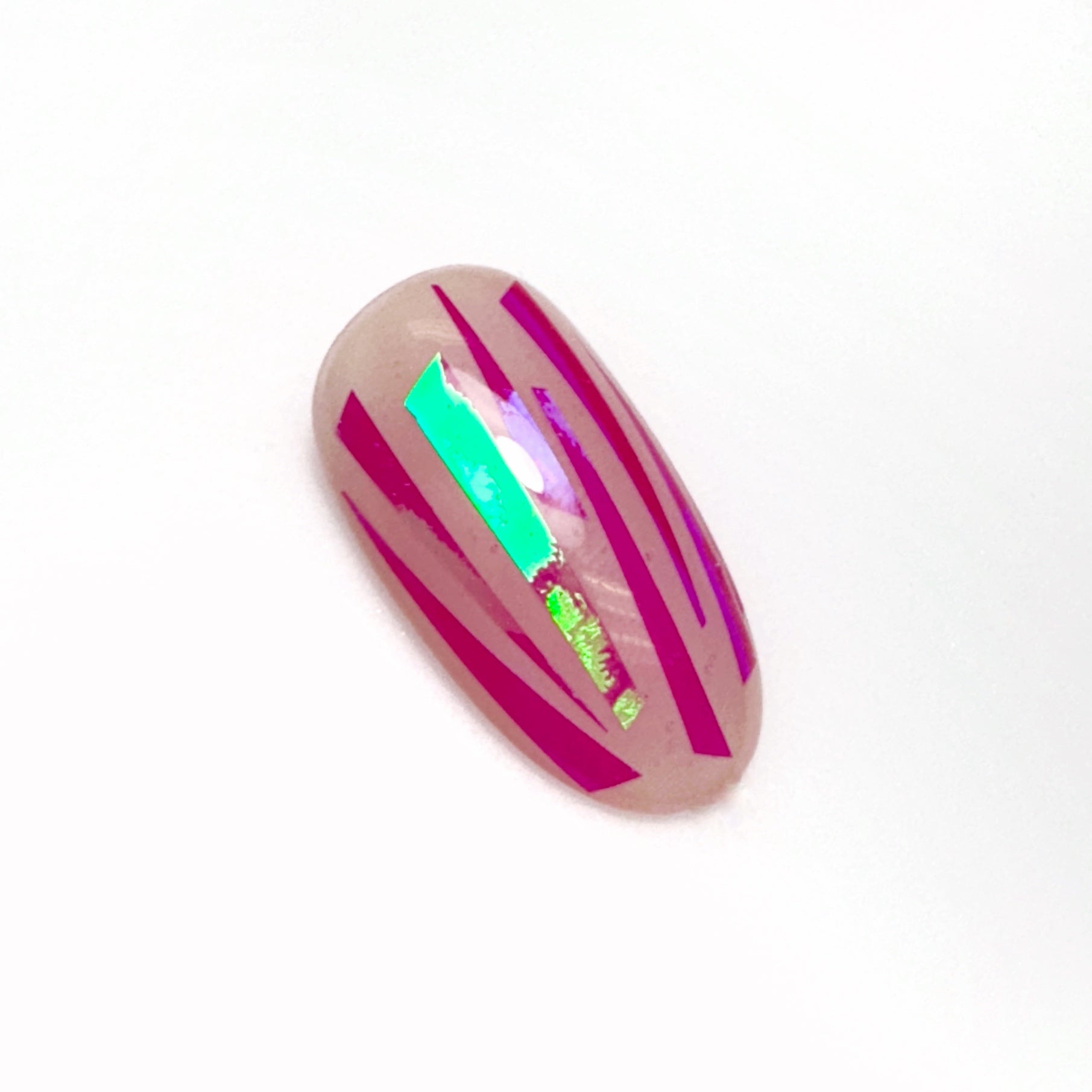 Decorated nail tip on a white surface.