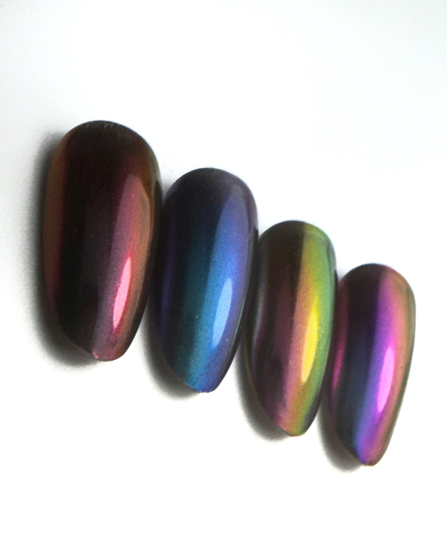 Close up of decorated nail tips on white surface 
