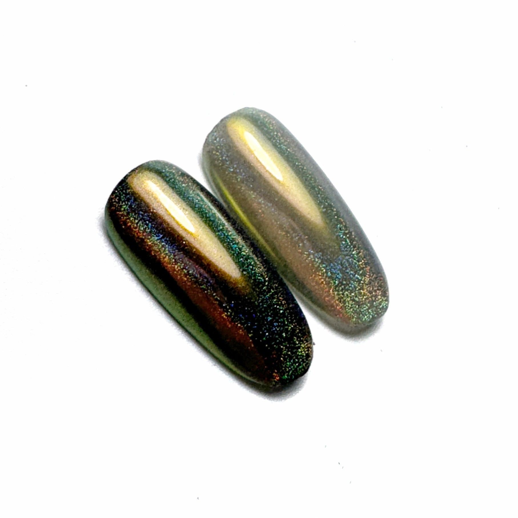 Nail tips with iridescent finish on white surface,