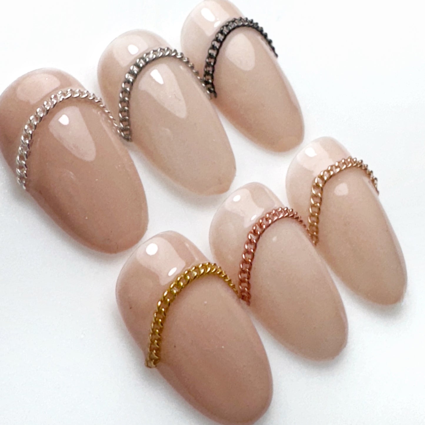 Decorated nail tips on a white surface.