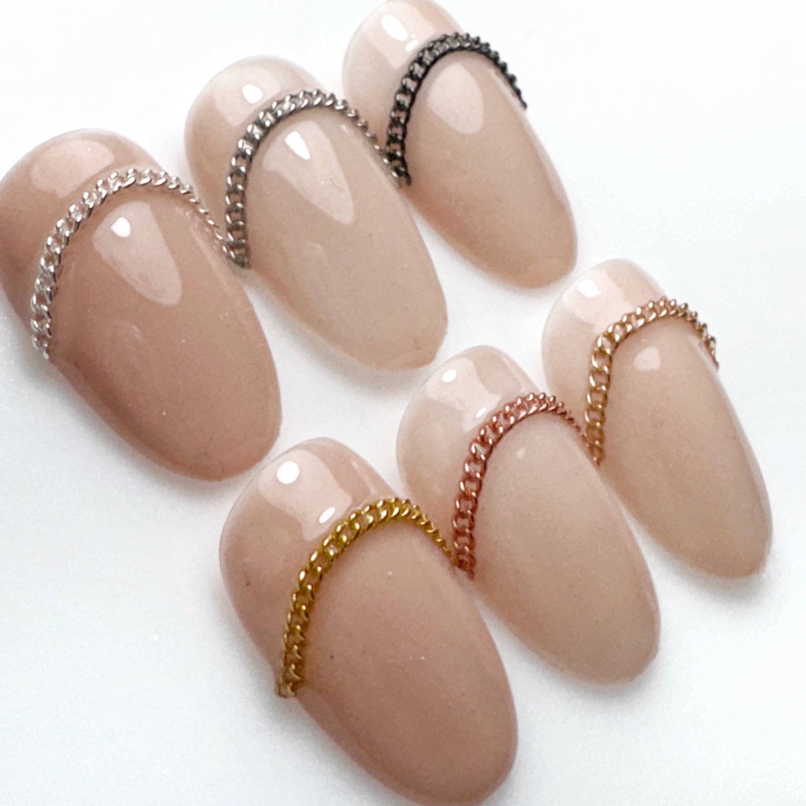Decorated nail tips on a white surface.