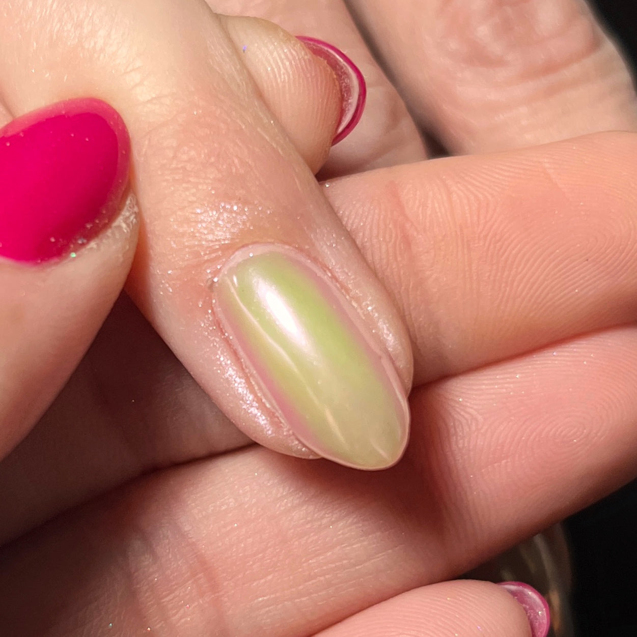 Close up of hand with holding finger on dark background.