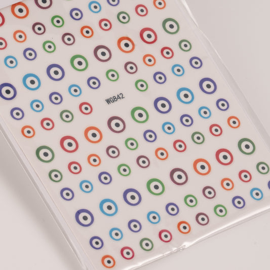 Nail decal sheet with colorful eye design on light background.