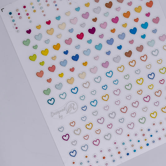 Sheet of colorful heart and polka dot stickers on a white background