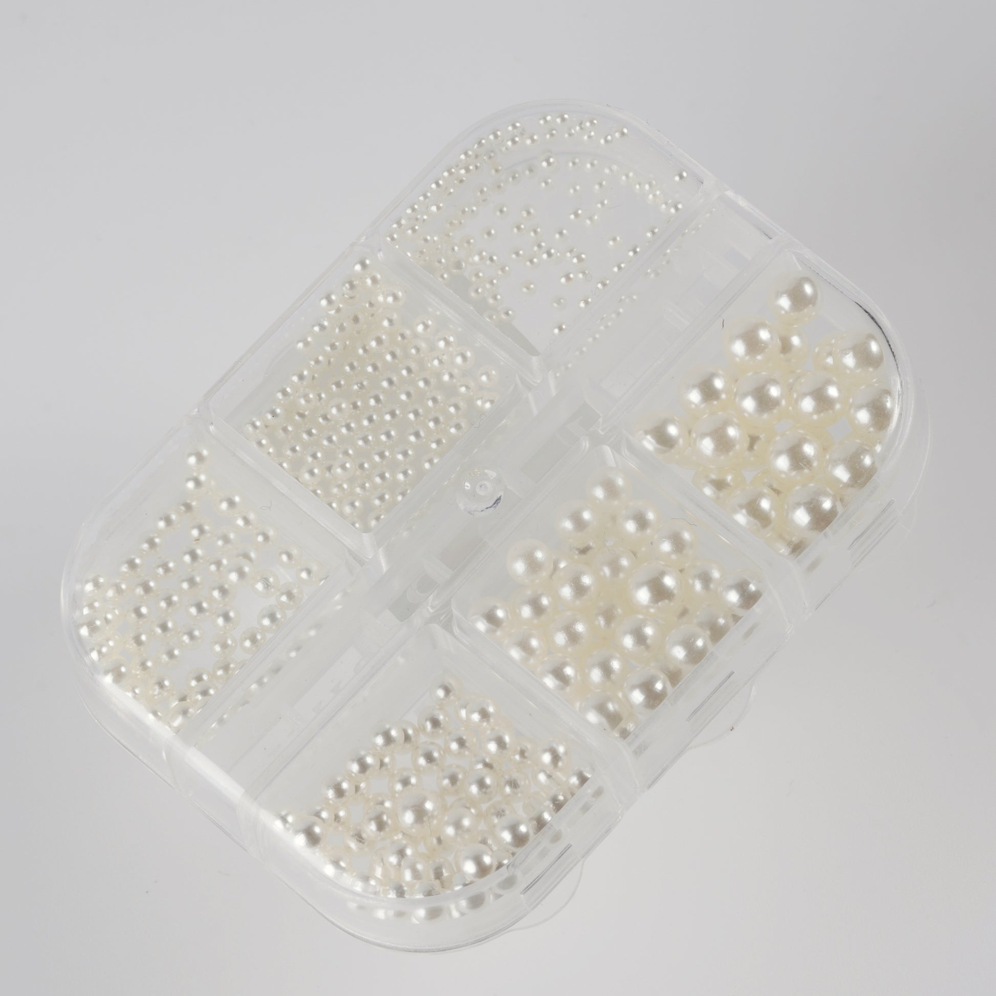 Clear case with ivory pearls on white background.