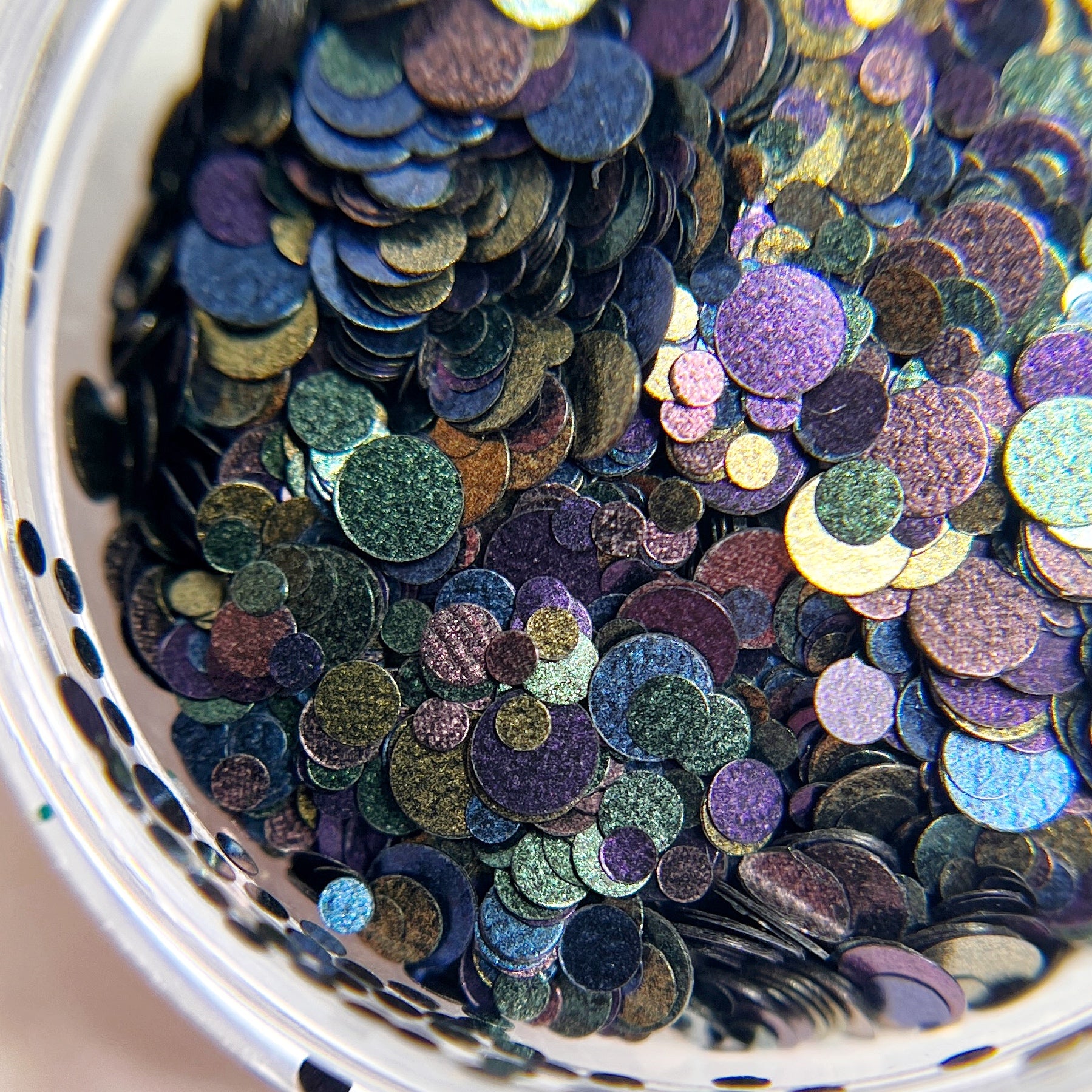 Multi-size circle glitter in clear jar. 