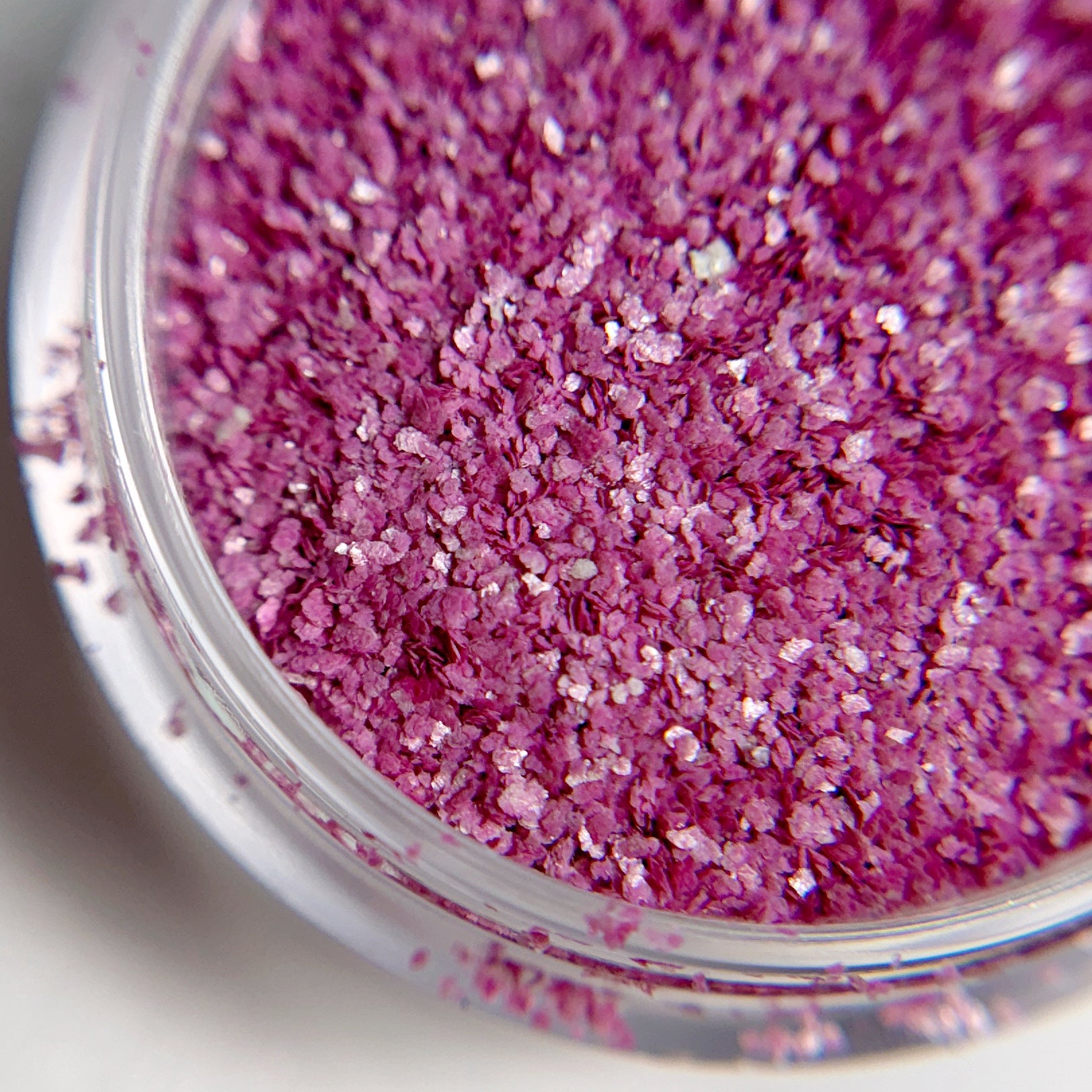 Close-up of pink glitter in a clear container