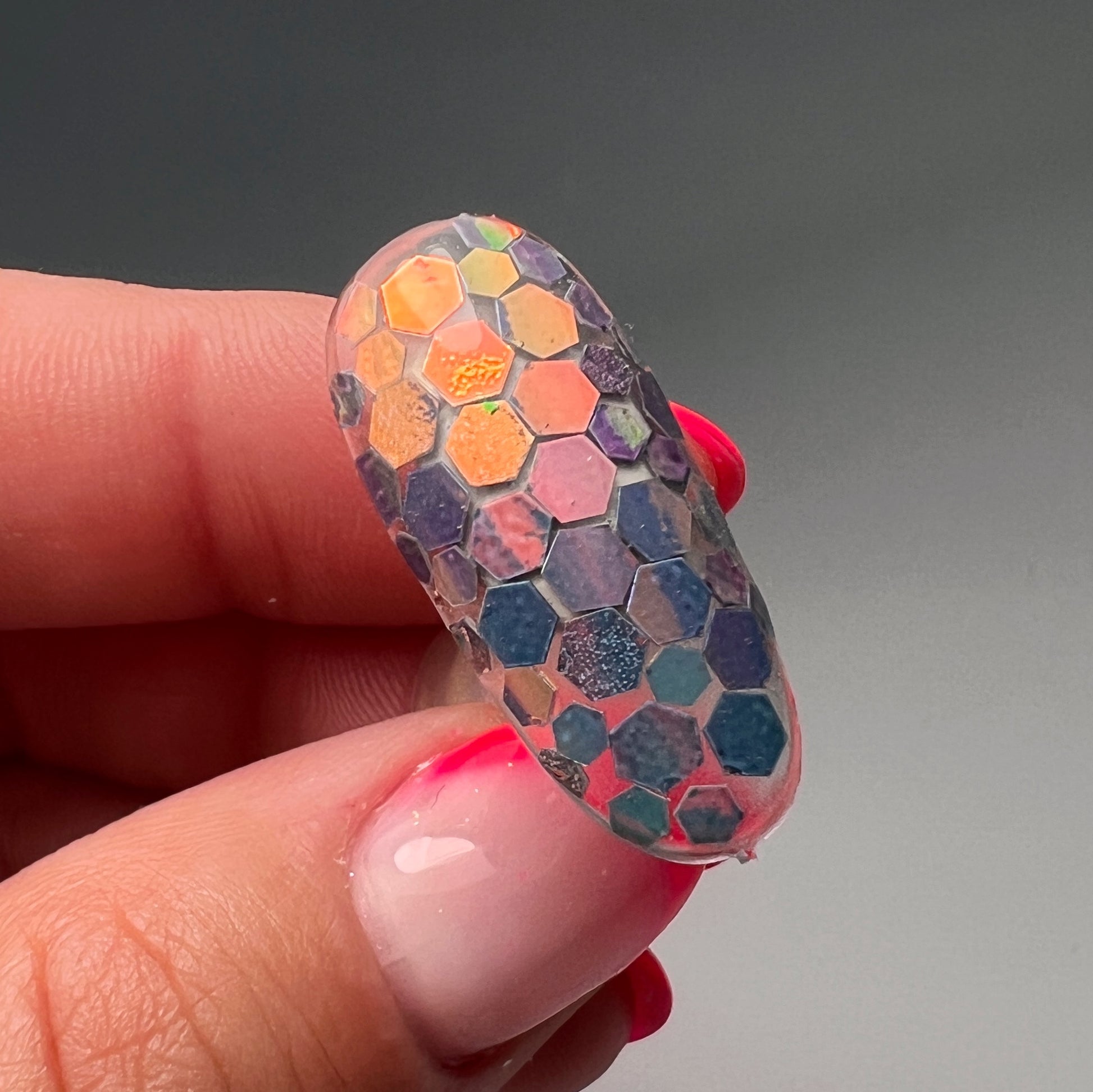 Hand holding decorted nail tip