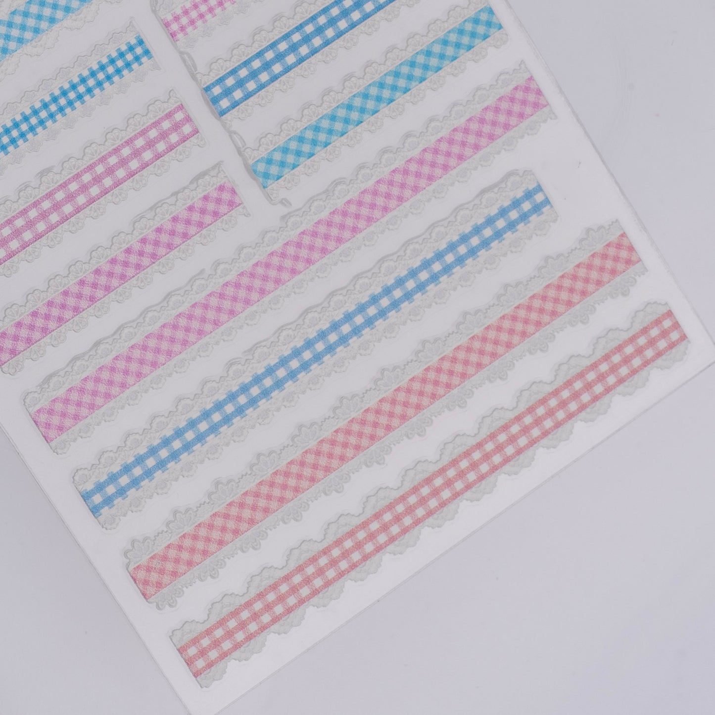 Checker design nail stickers on white background.