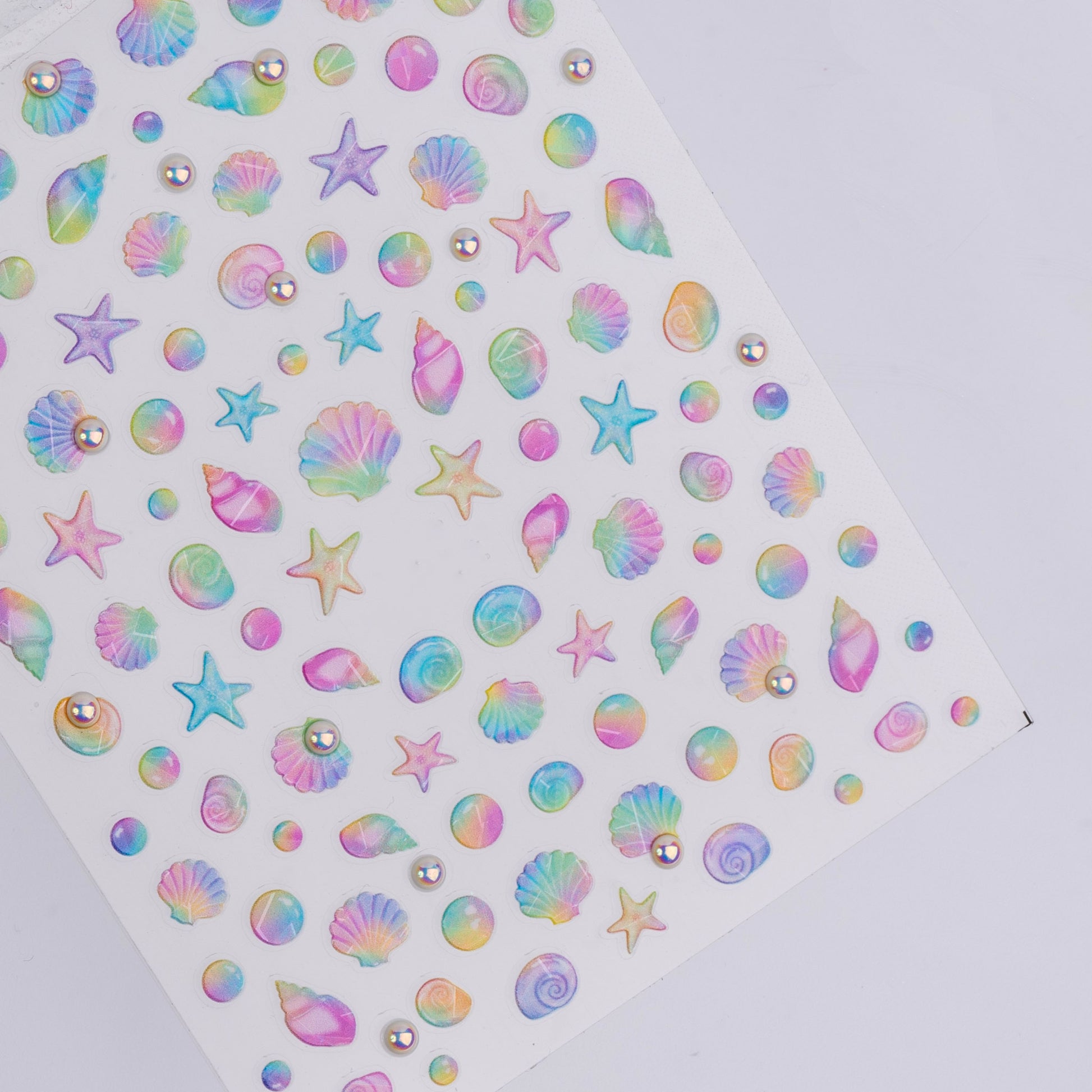 Sheet of colorful starfish and shell stickers on a white background