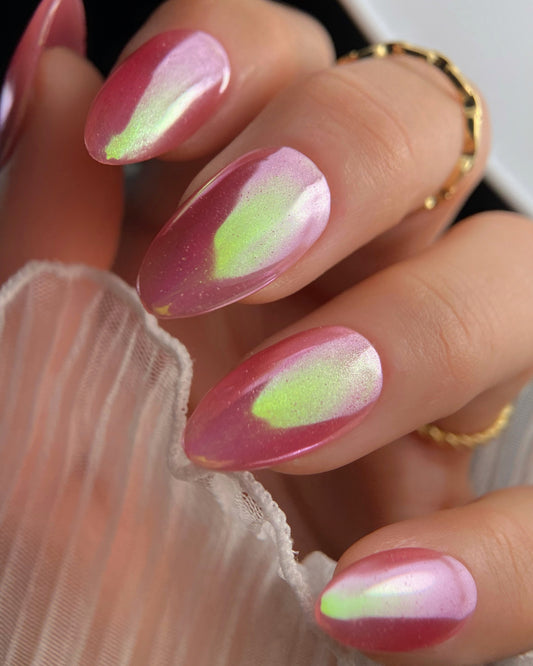 Nails with pink and green design on a blurred background