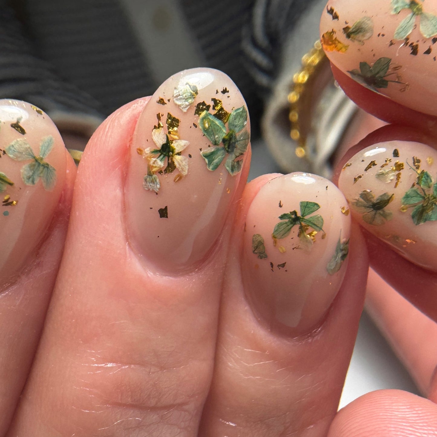 Nails with floral nail art on a blurred background