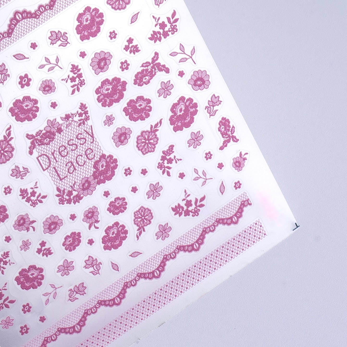 Detail view of nail decal sheet on light background.