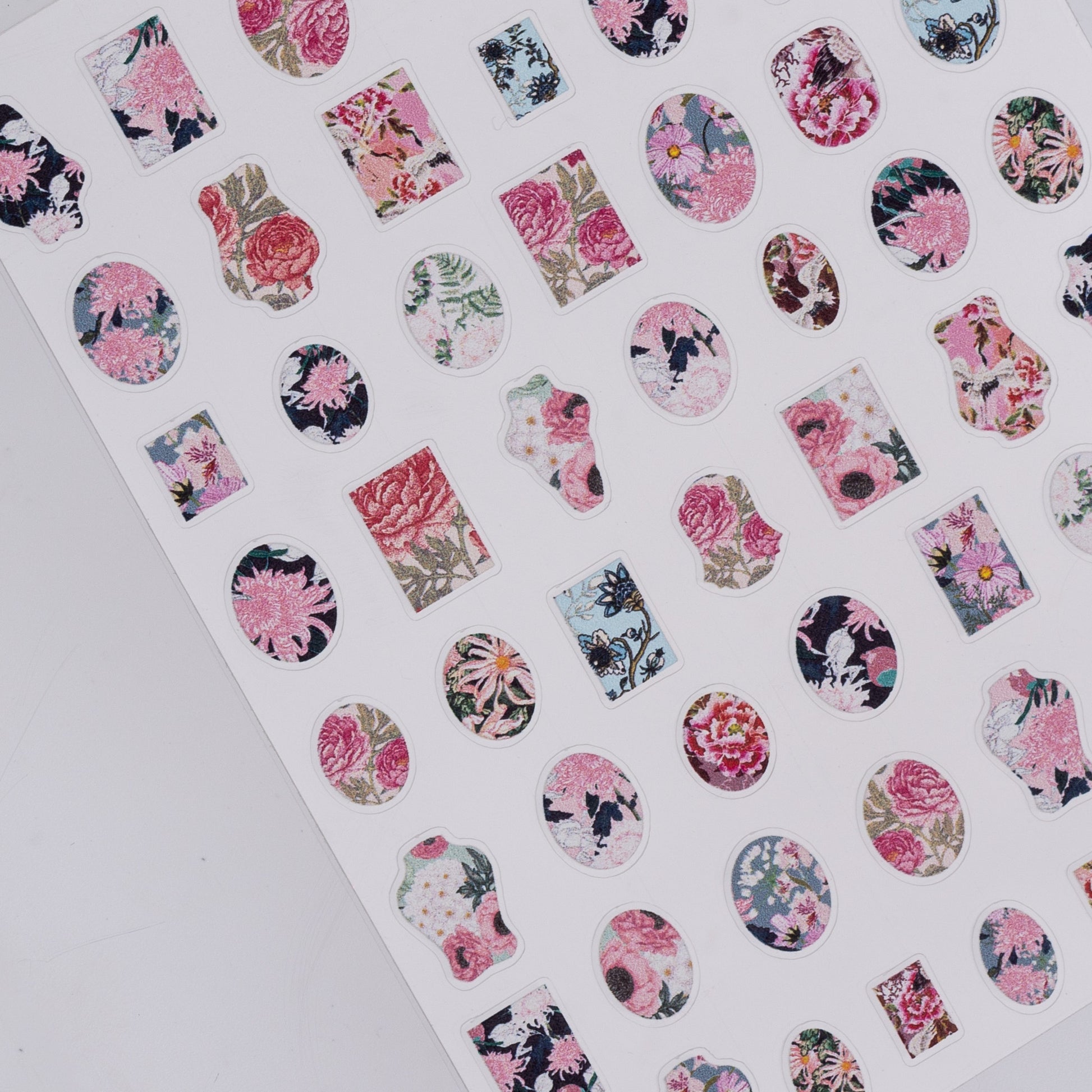 Sheet of floral nail art stickers on a white background