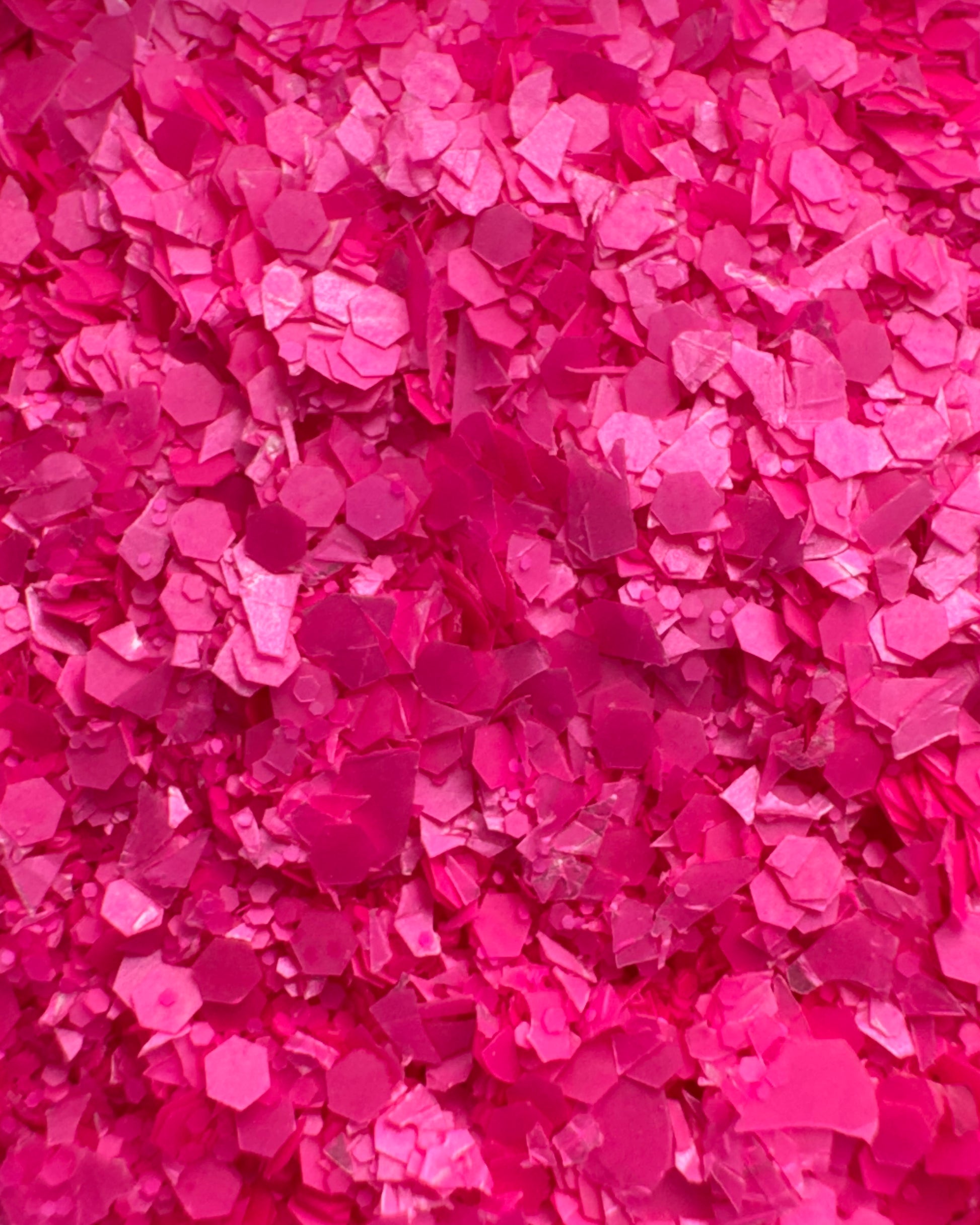 Close-up view of neon pink textured glitter.