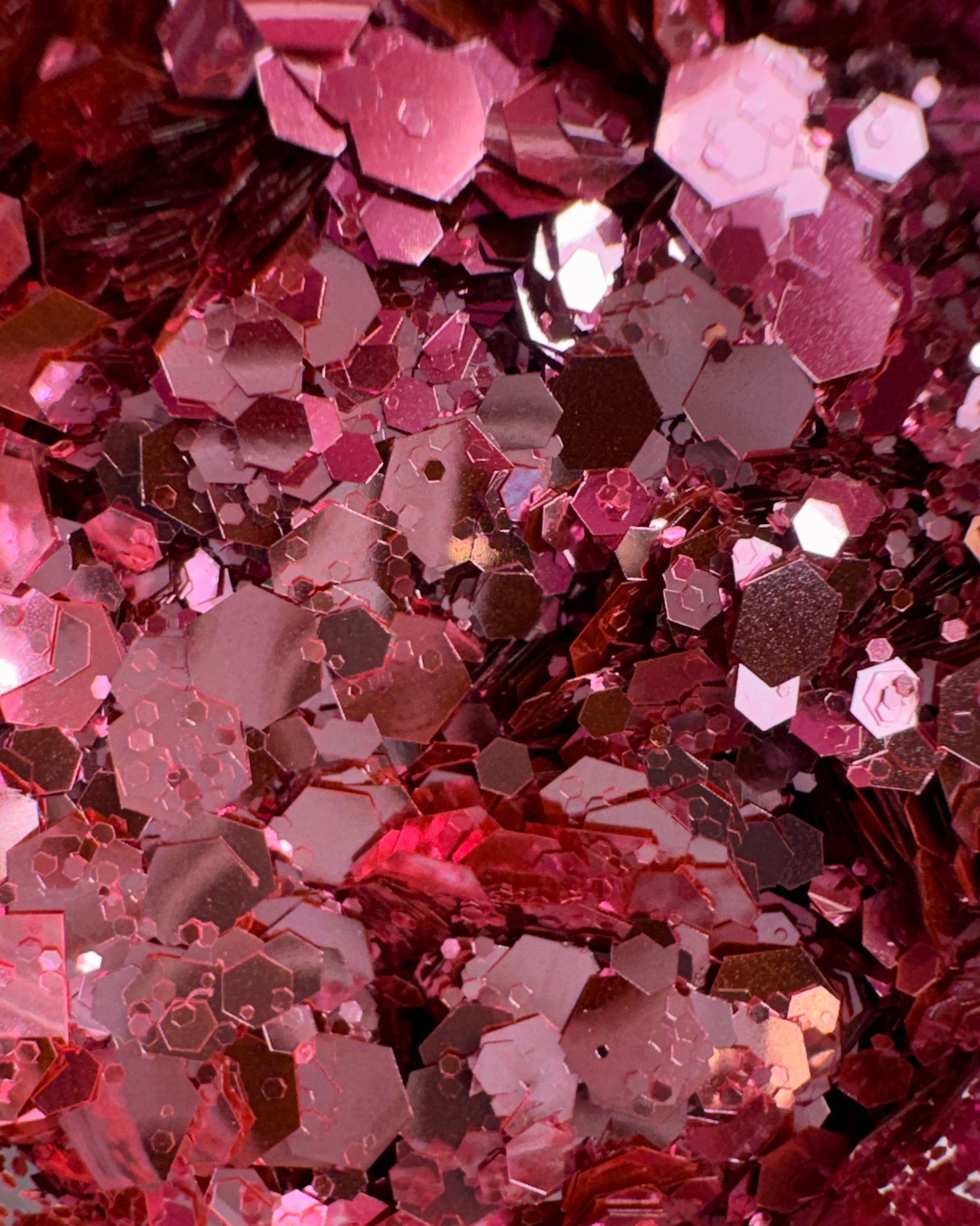 Close-up of metallic hexagonal pink glitter mix.
