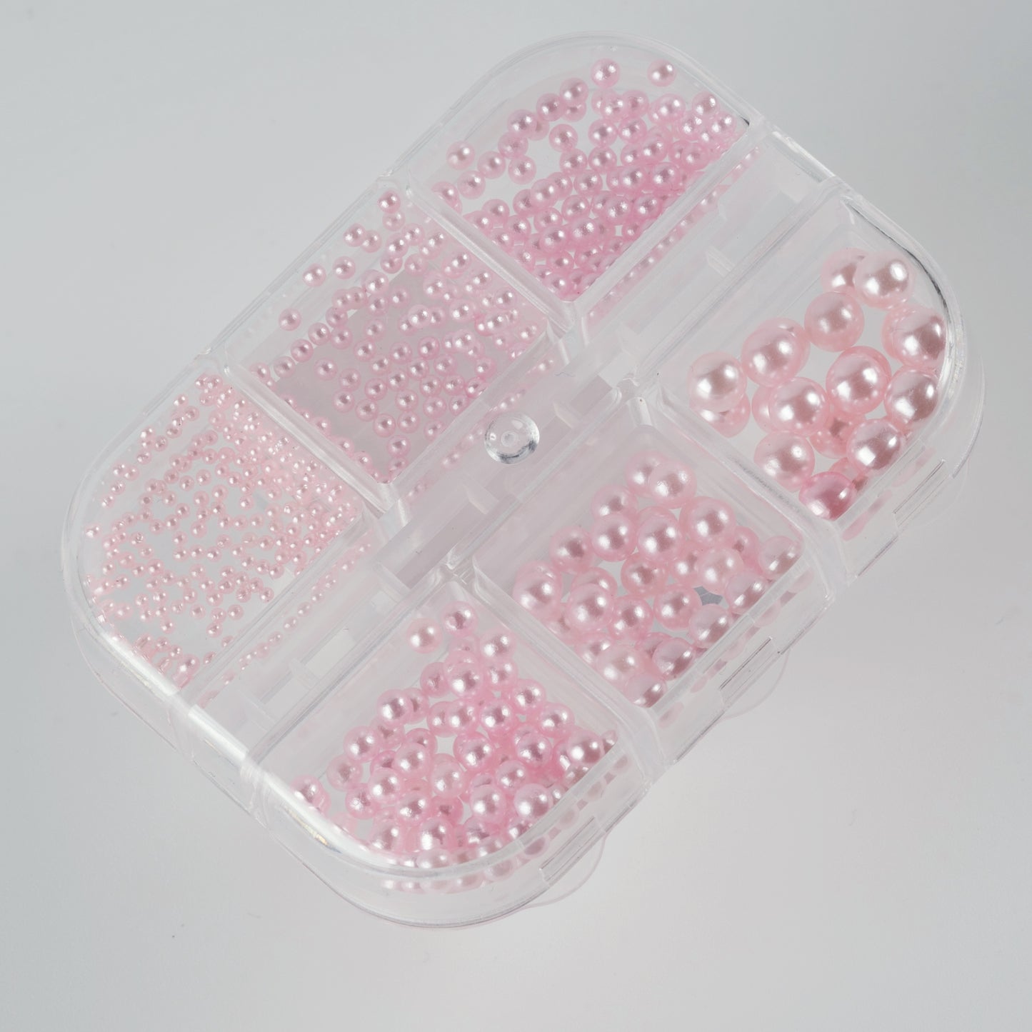 Clear case with pink pearls on white background.
