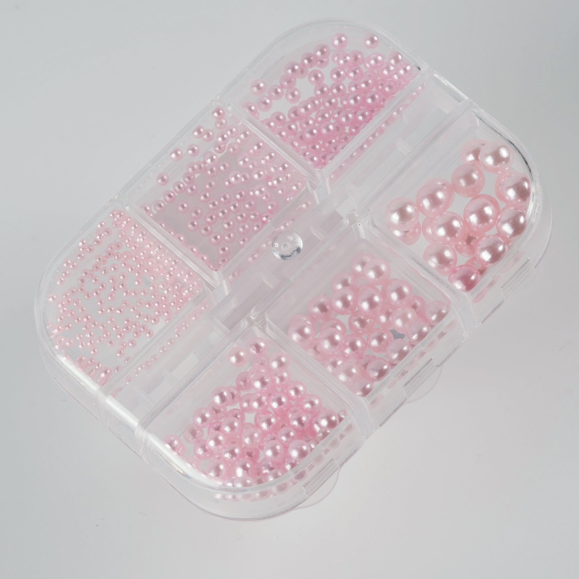 Clear case with pink pearls on white background.
