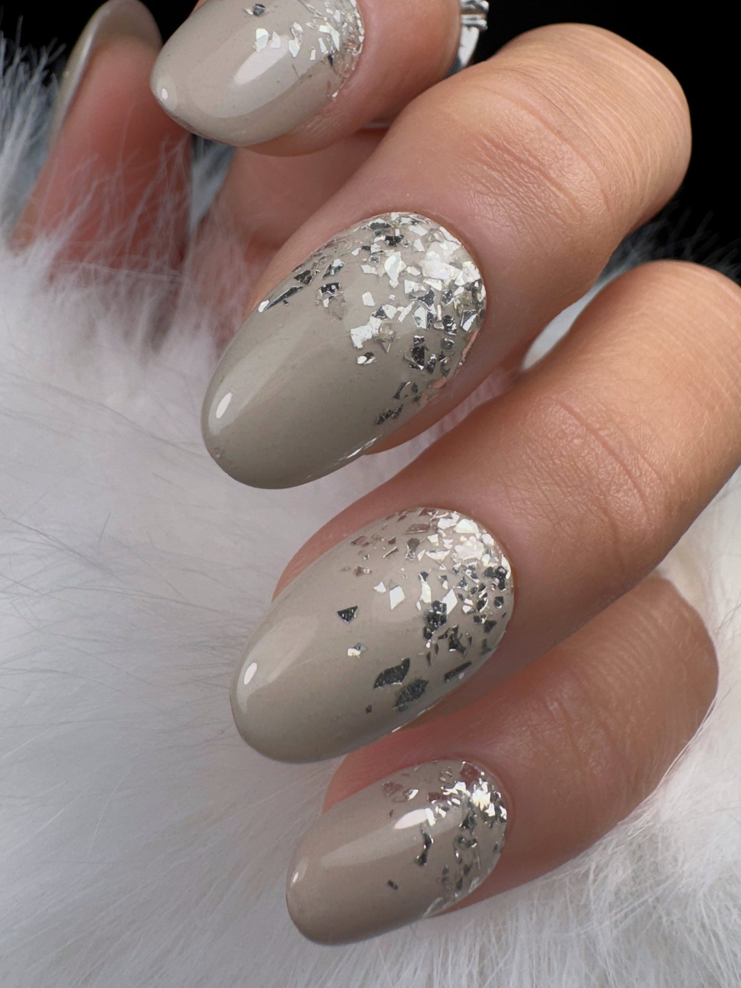 Nail art with silver glitter on a white background
