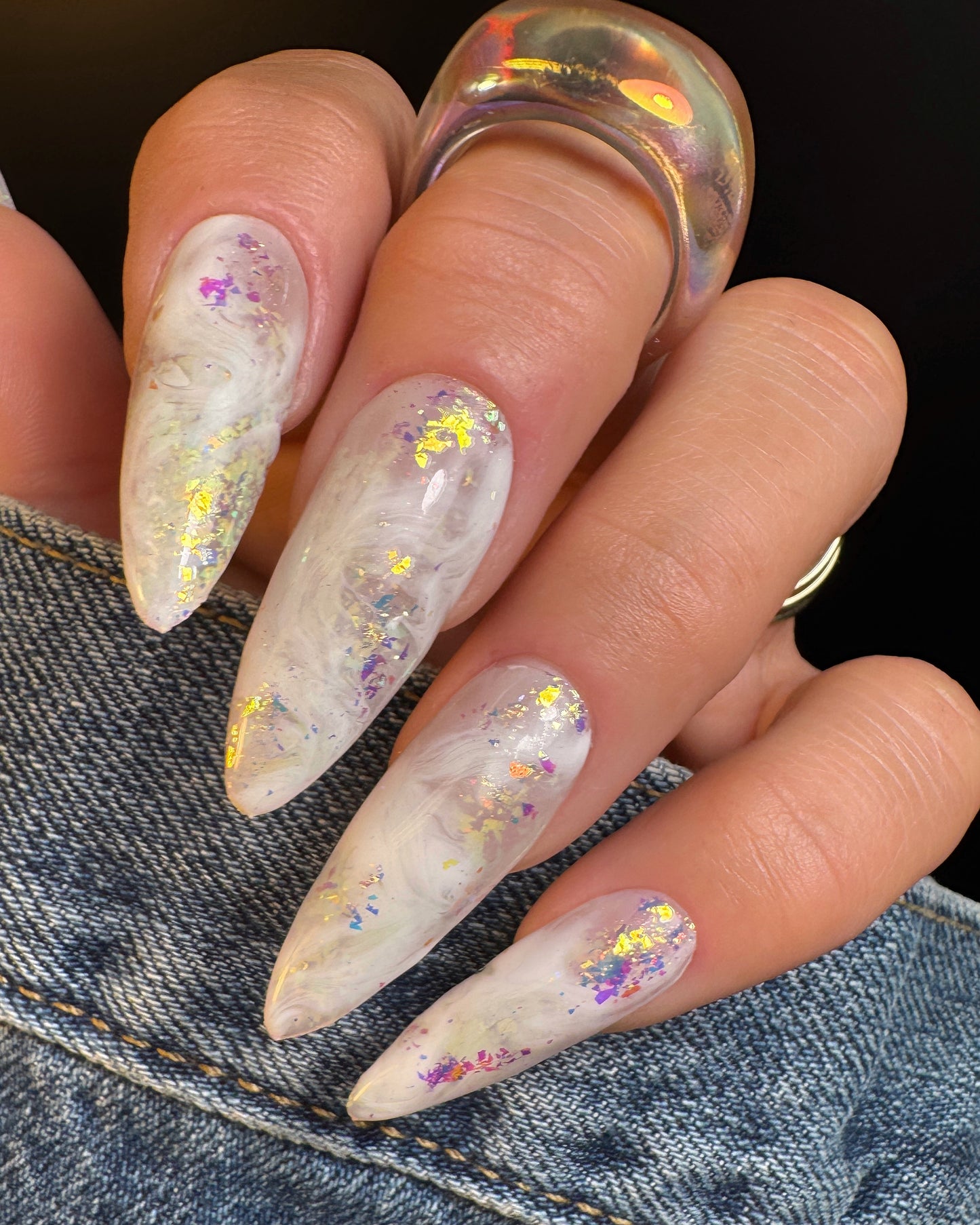 Nails with a glittery design on a denim background