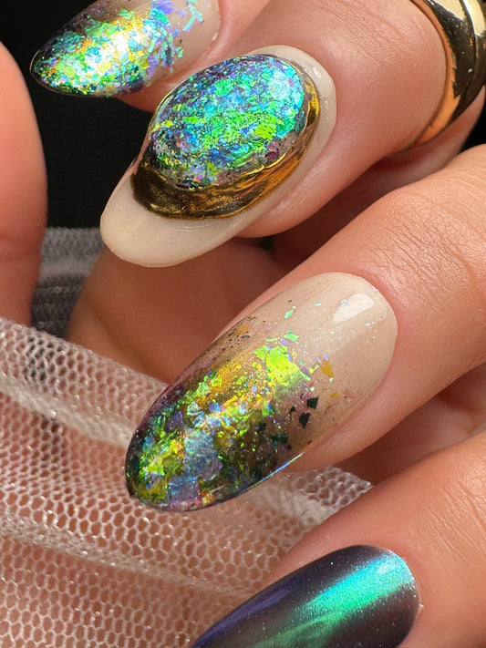 Nails with multicolored glittery design on a clear background