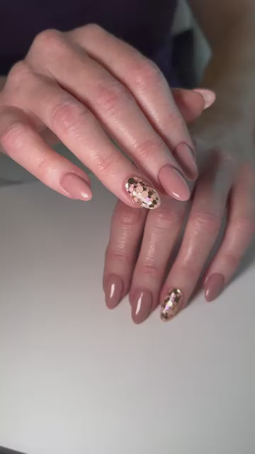 Video of a nude manicure by nail artist Melissa Robillard featuring Vacation Nail Shop Rose & Champagne Spots Glitter, with scattered metallic rose and champagne glitter accents on select nails.