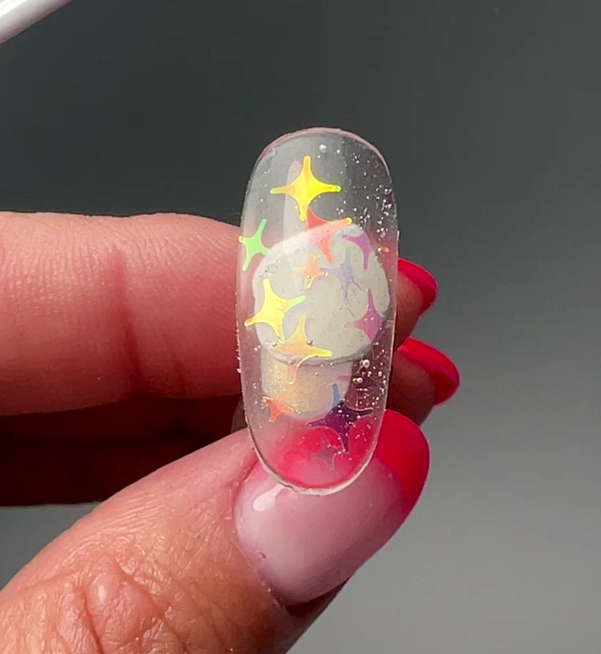 Video of hand holding a nail tip on gray background. 