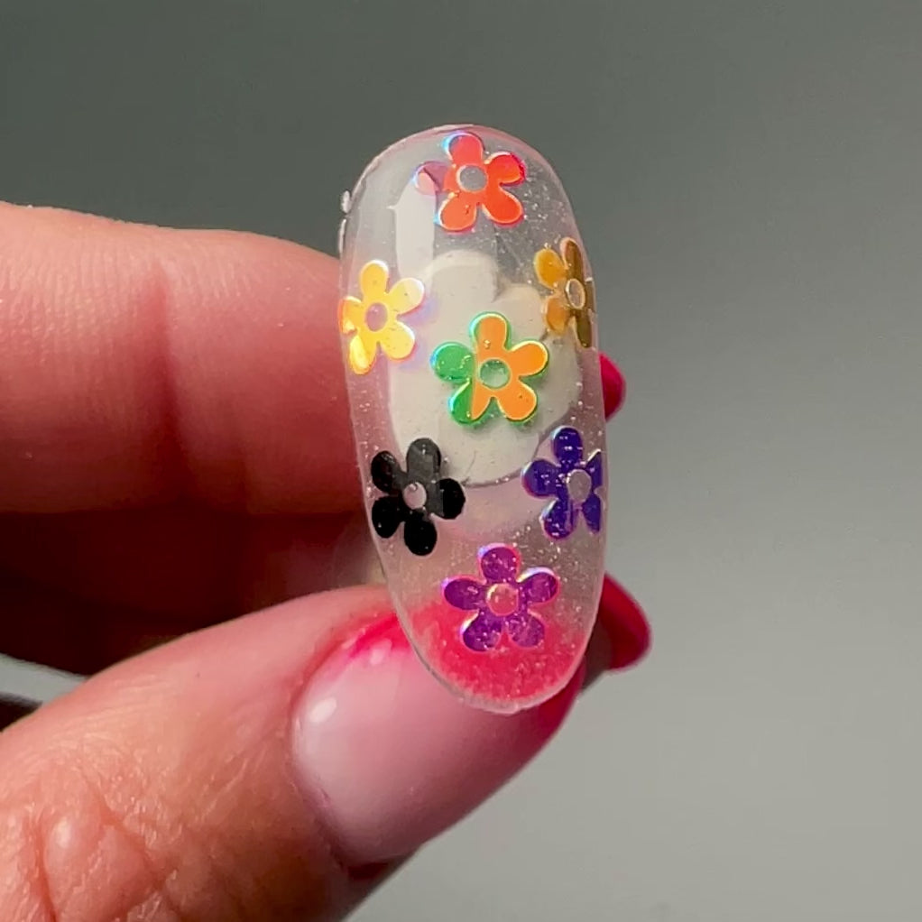 video of hand holding decorated nail tip
