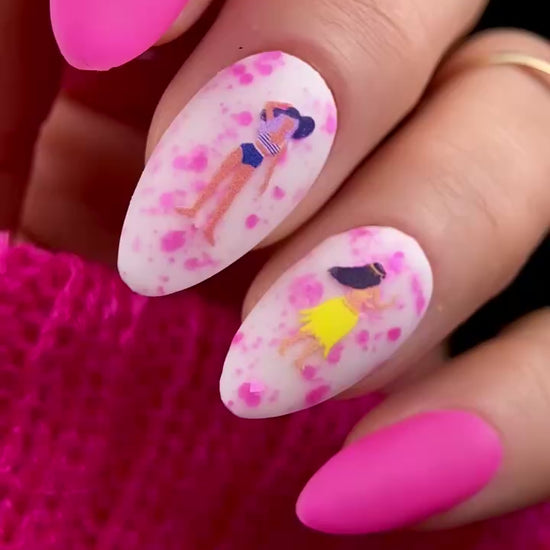 Video of nails with cartoon design and pink accents.