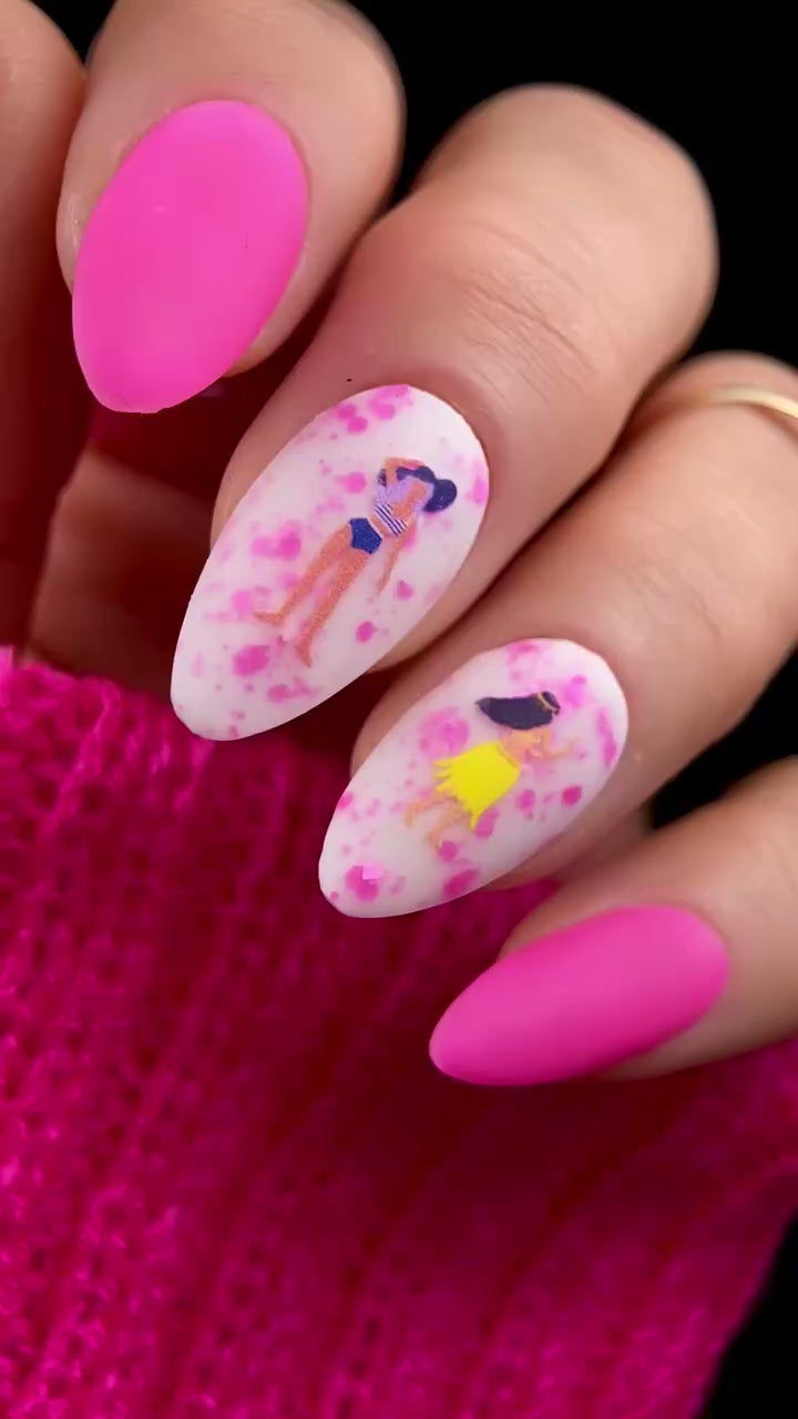 Video of nails with cartoon design and pink accents.