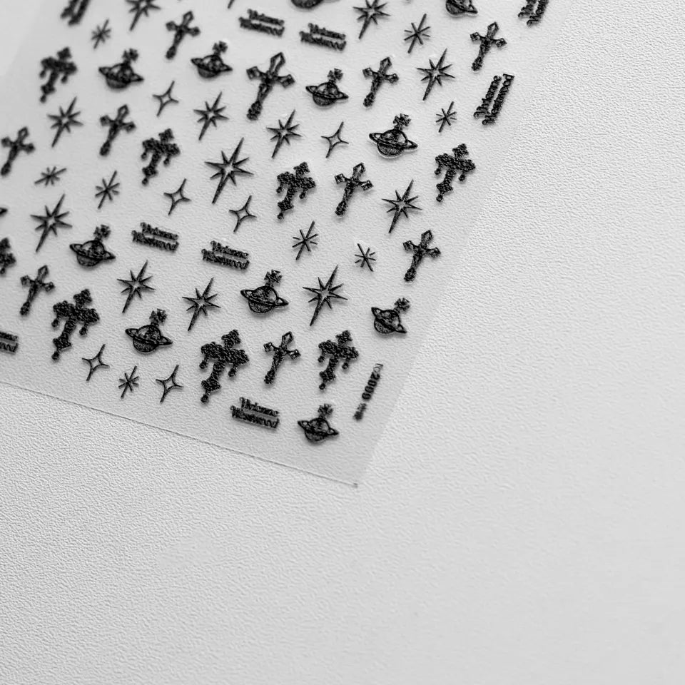 Punk Cross Nail Stickers - Textured Nail Stickers with Extravagant Cross Designs in Black, Displayed on a White Background."