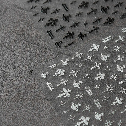 Punk Cross Nail Stickers - Textured Nail Stickers with Extravagant Cross Designs in Black and White, Displayed on a Gray Background."
