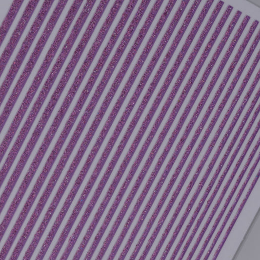 Close-up view of purple glitter line nail stickers on white background.