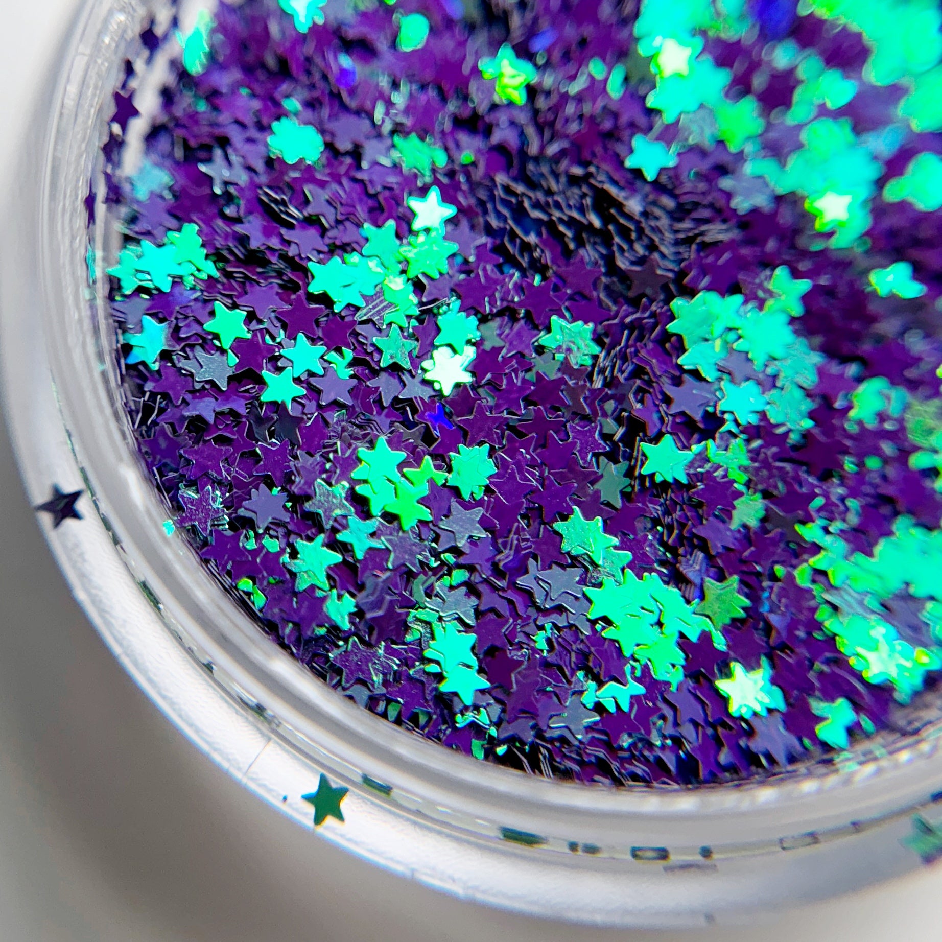 Close up of star glitter in clear container.