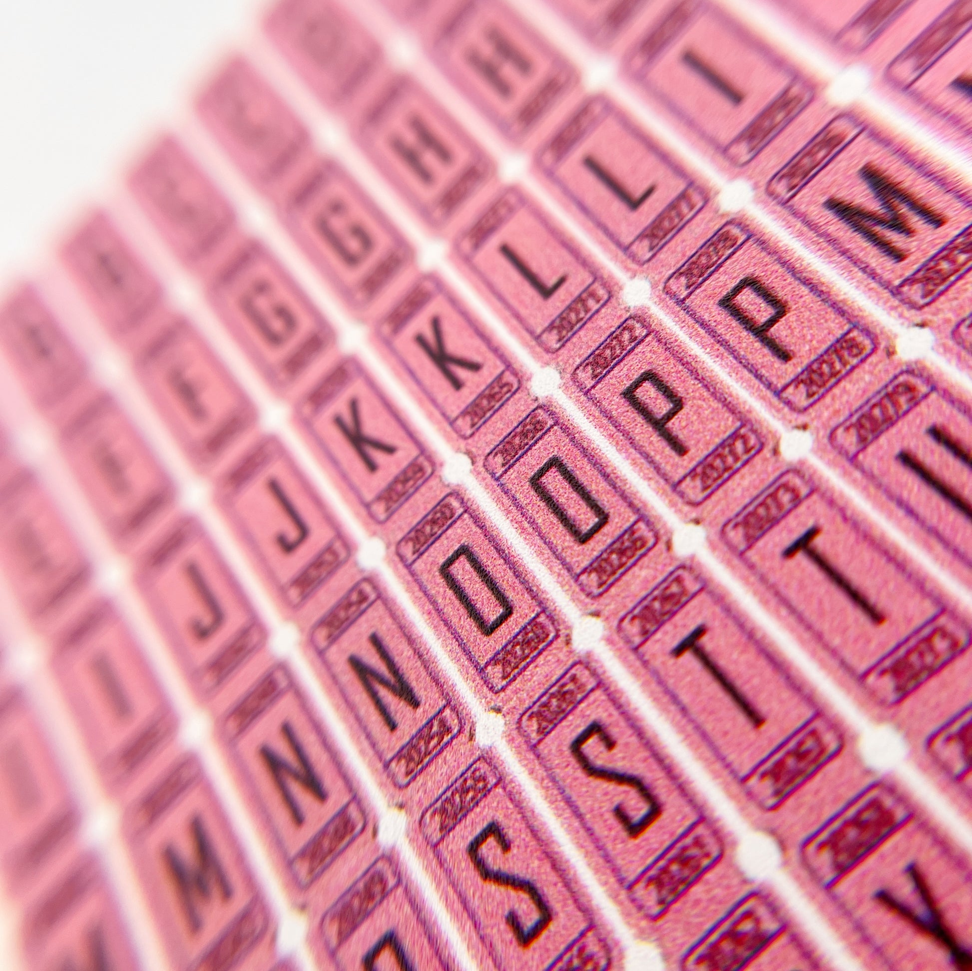 Raffle Ticket Nail Stickers - Pink Alphabet Nail Stickers Resembling Raffle Tickets, Displayed on a White Background.