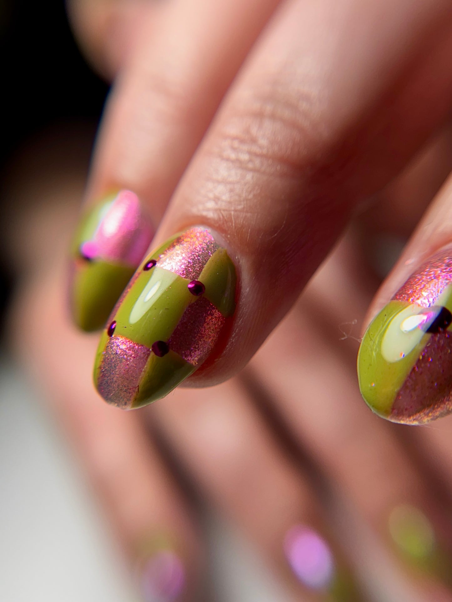 Close up of detailed nail art on blurred background