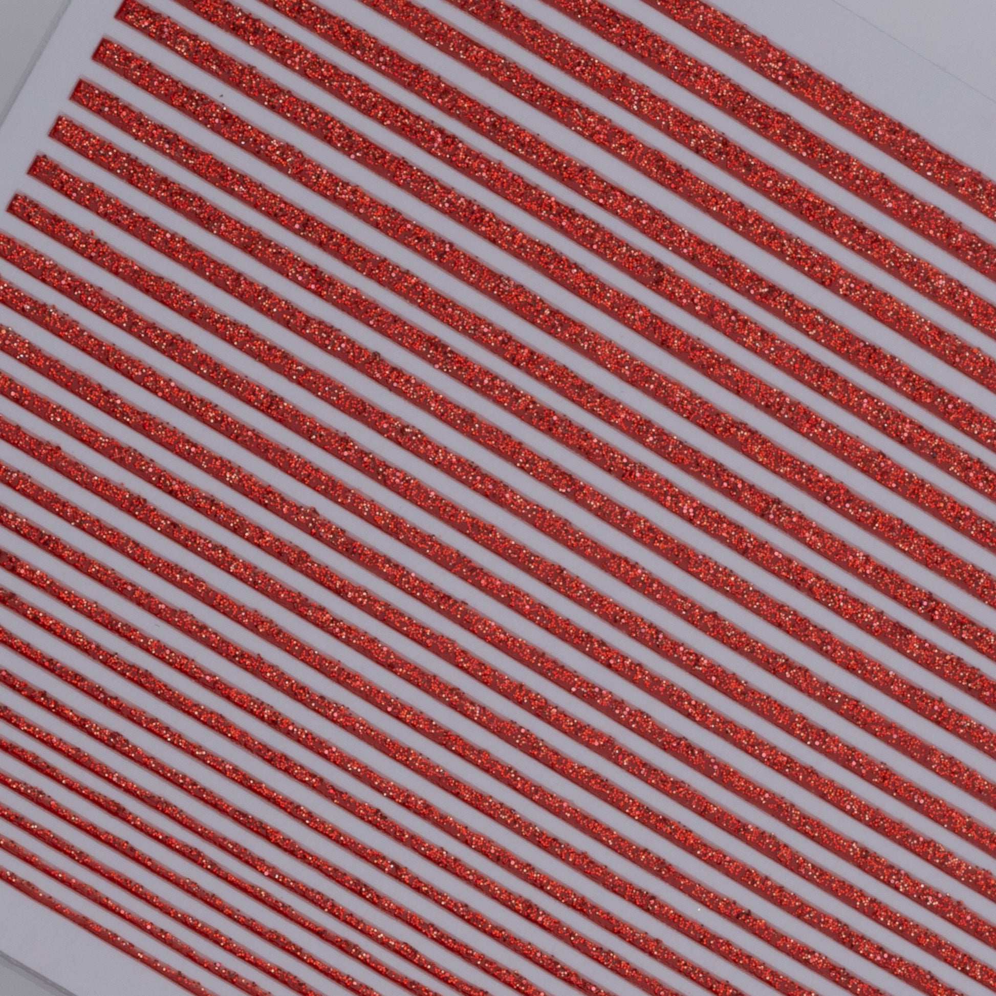 Close up view of decorated nail tips on white background.
