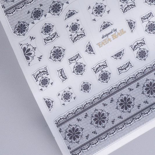 Sheet of floral nail art stickers with 'designed by TATA Nail' text on a gray background