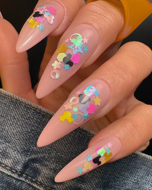Nails with colorful designs on neutral background 