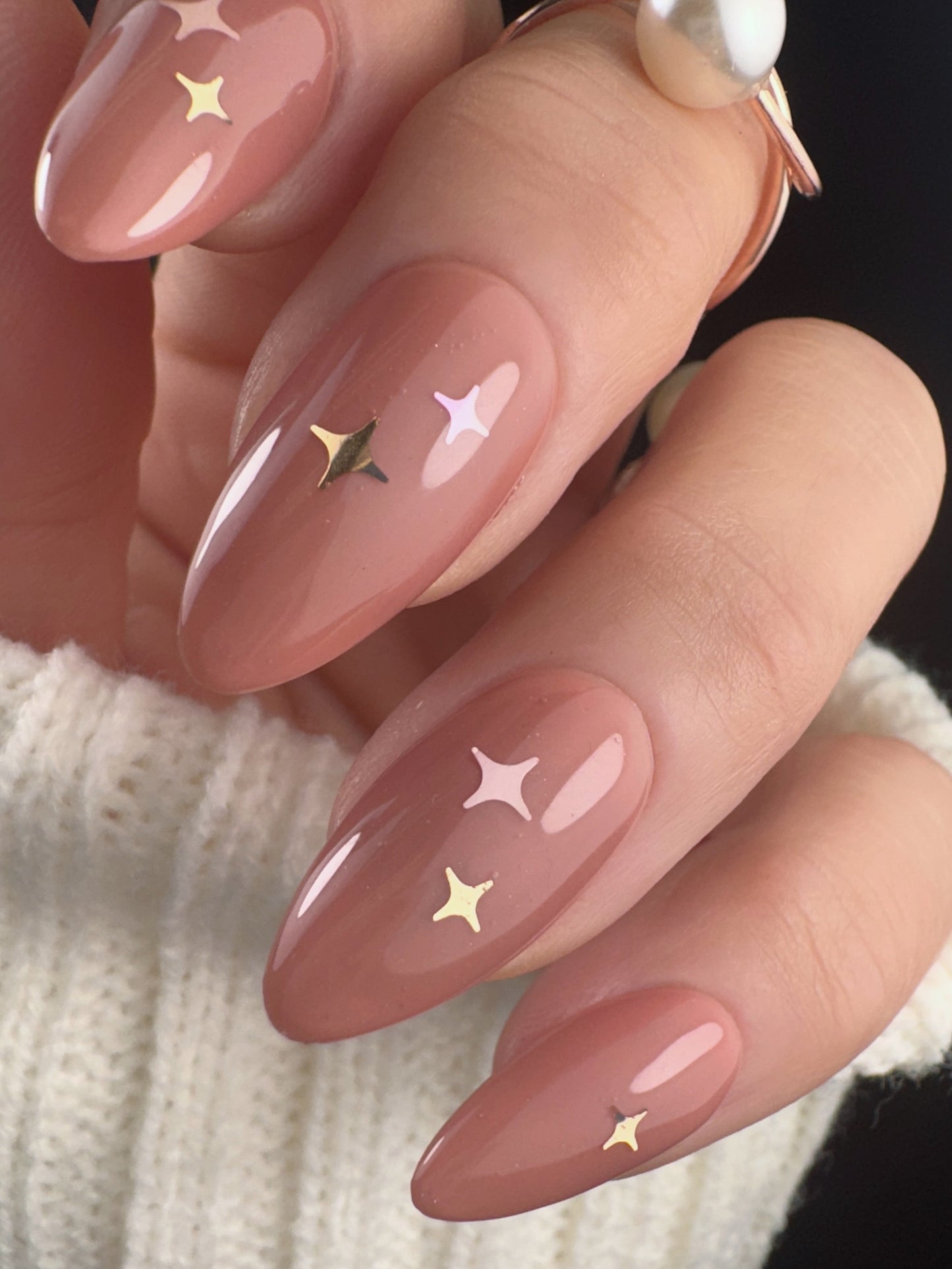Nails with star designs on a neutral background