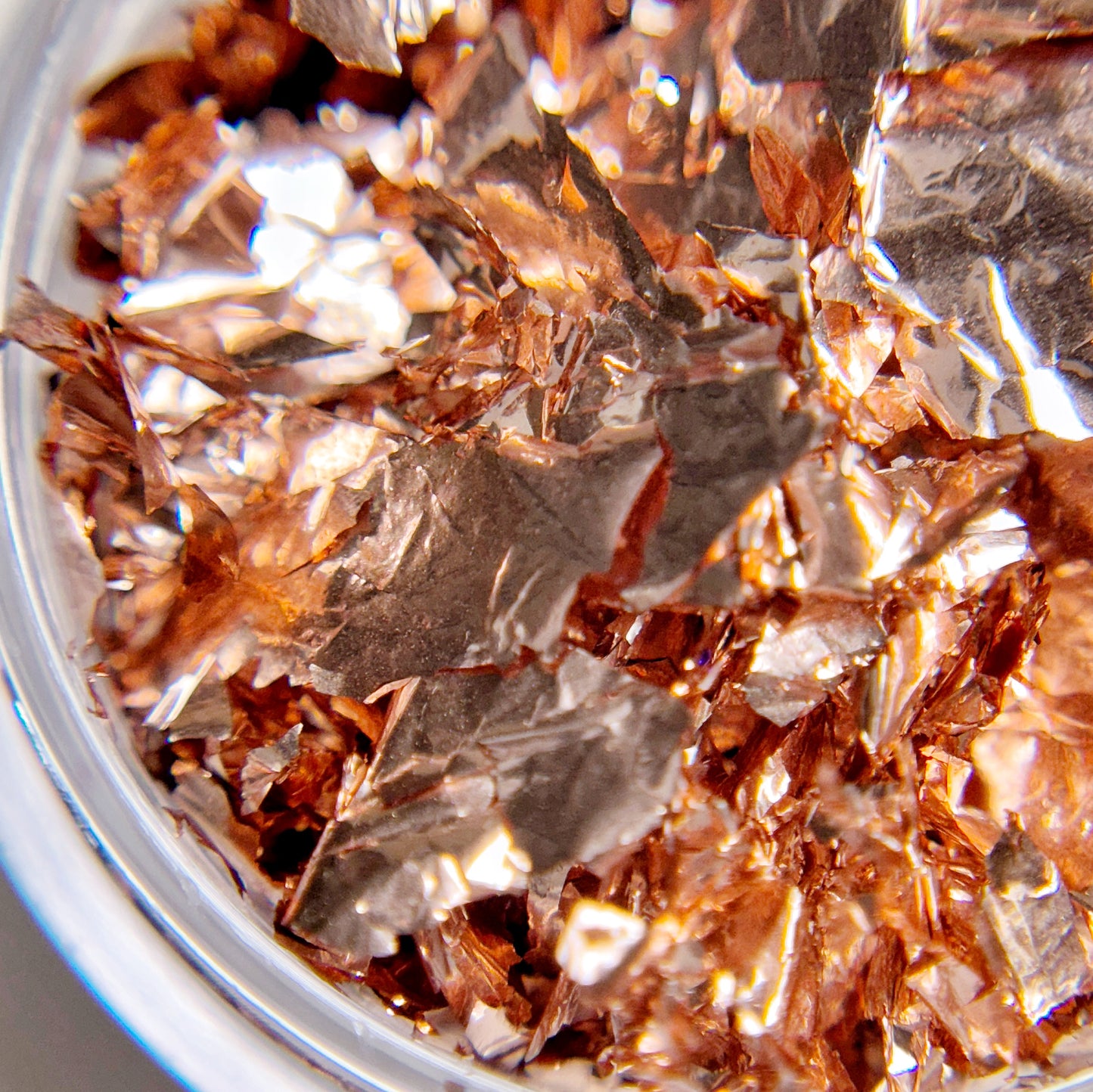 A close-up view of rmetallic flakes with a reflective surface.
