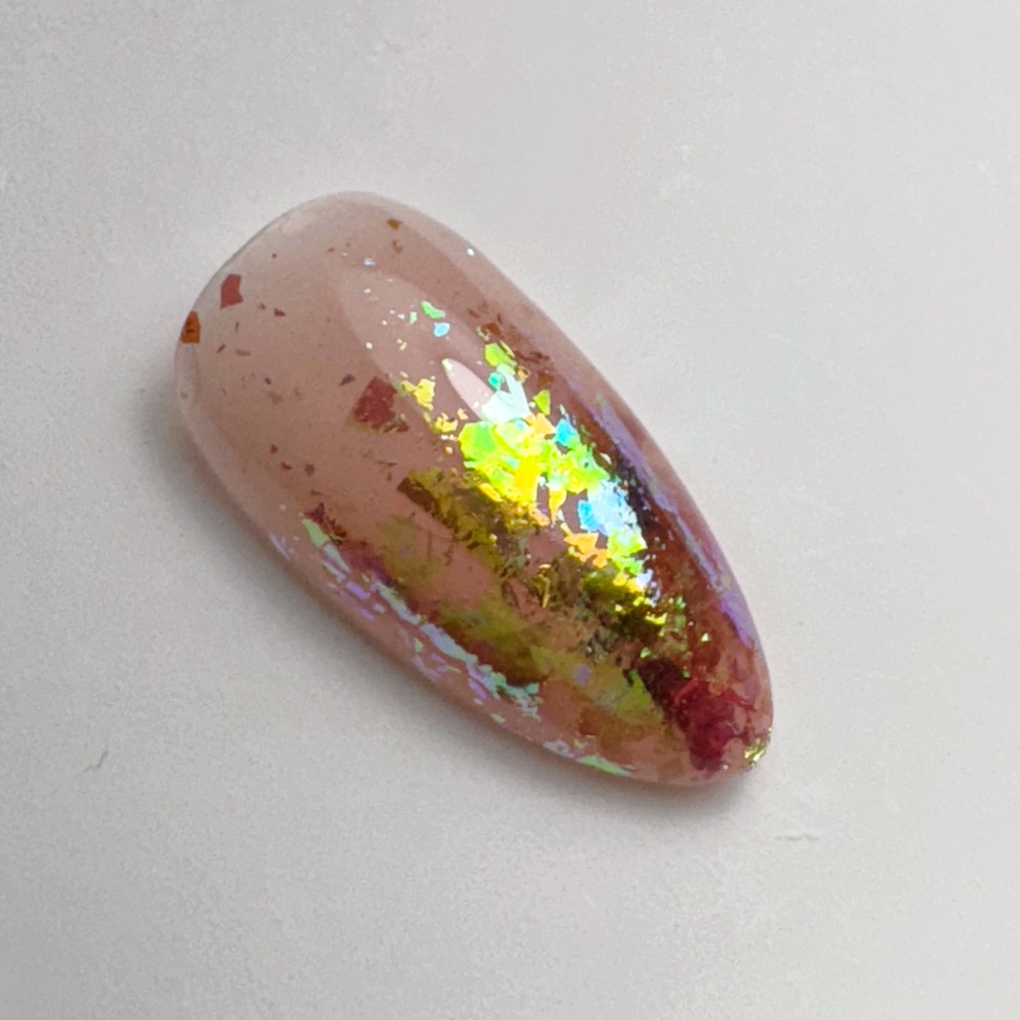 decorated nail tip on white surface